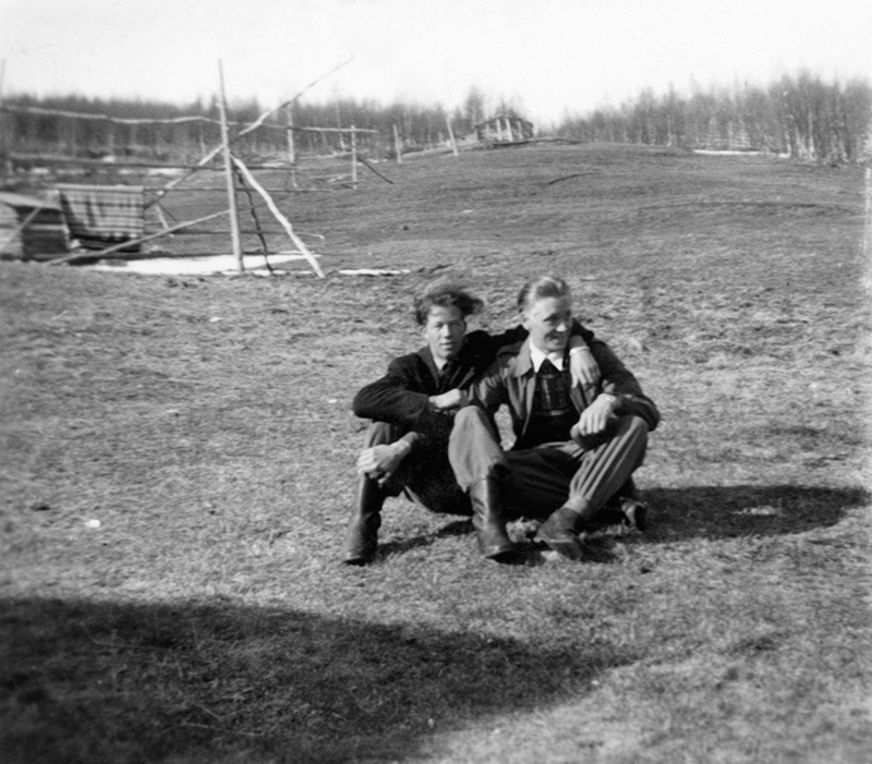 Två  män sittandes i gräset.