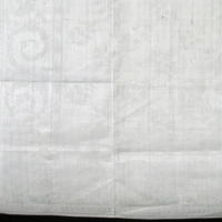 SLM 5411 - Servett av vit linnedamast, blomstermotiv, märkt 