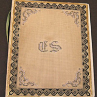 SLM 11957 3 - Bokpärm av papp och textil, korsstygnsbroderier och initialerna E.S.