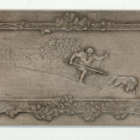 SLM 8150 - Plakett av silver, relief med skidåkande man och varg