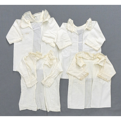 SLM 54993, 55000, 55001, 55003 - Fyra babyskjortor av vit bomull, merparten med volangkrage