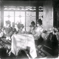 SLM M034120 - Fyra kvinnor och en man sitter runt ett bord.
