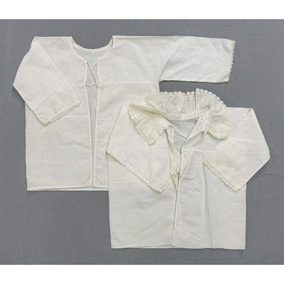 SLM 54783, 54786 - Två babyskjortor av vit bomull, merparten med volangkrage