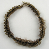 SLM 5224 - Halsband, hårarbete, håret flätat i spiral kring en central stomme, spänne saknas