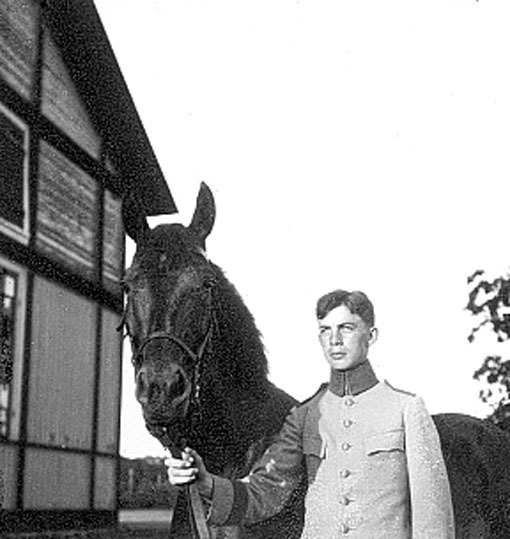 Bilden visar en elev och hans häst utanför stal...